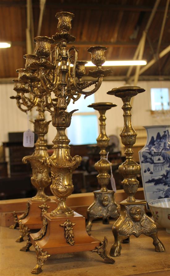 Pair of four light three branch candelabra on marble base and a pair of brass candlesticks